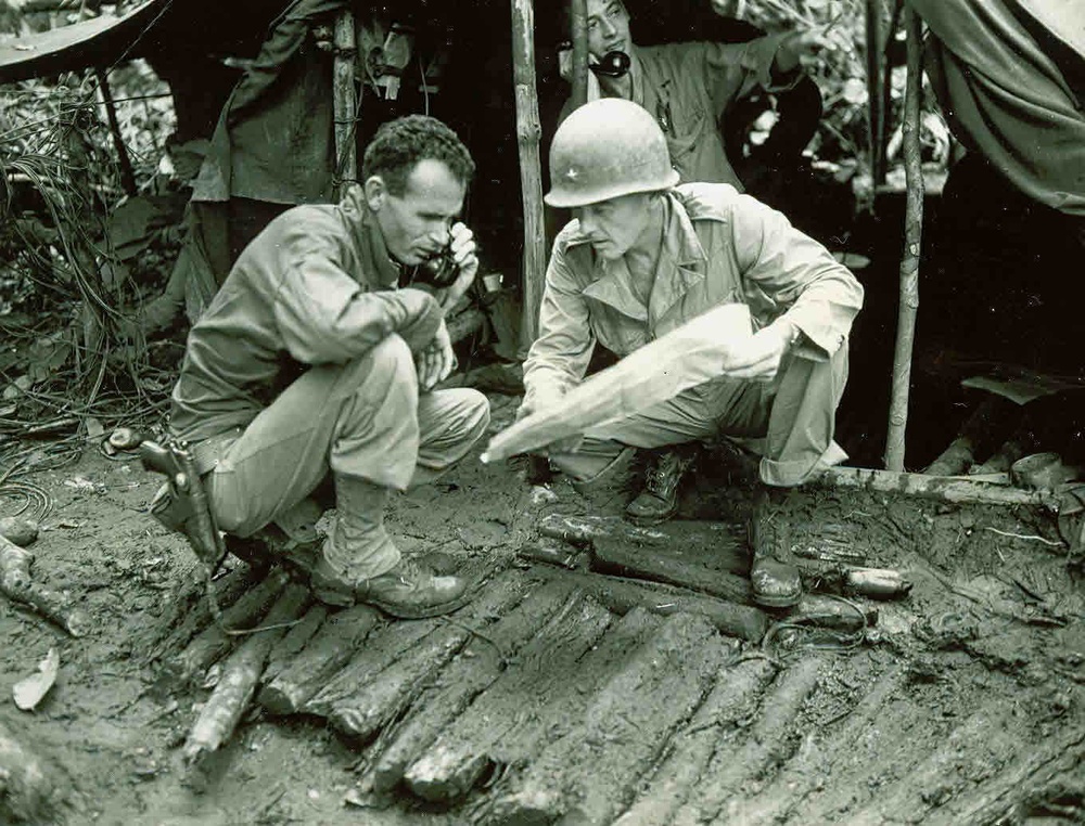 World War II officers studying a map at a command post for a Hearts of Iron IV console commands guide.